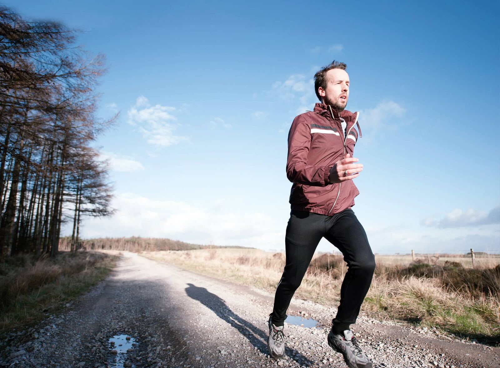Greg running on a gravel path